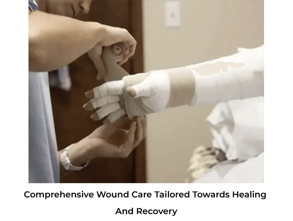 A person helps wrap a bandage around another person's hand.