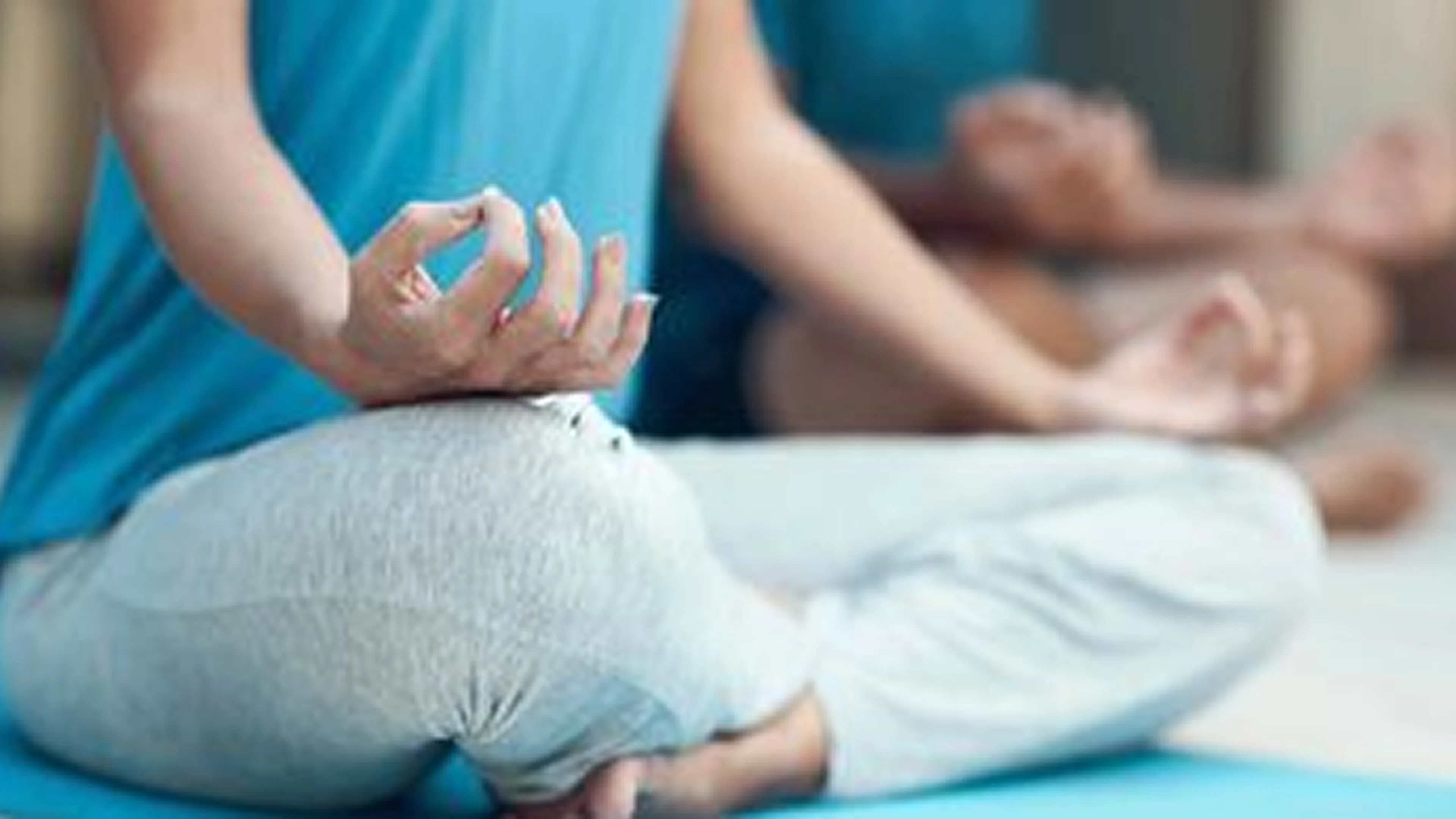 Person meditating in a serene environment.