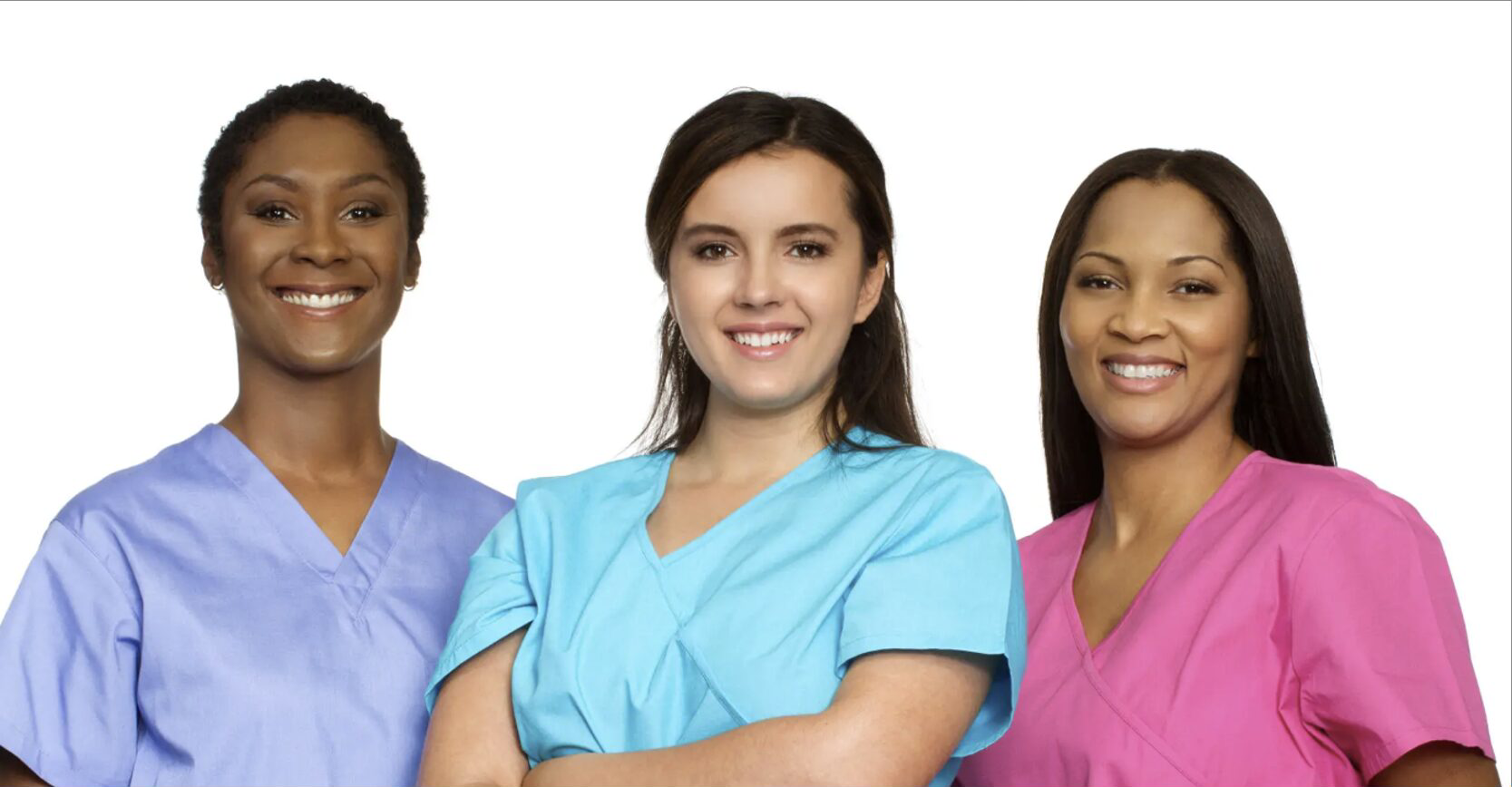 Three female healthcare workers in scrubs smiling confidently.